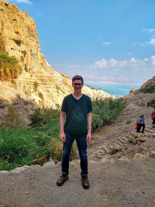 Adrian Rocke At En Gedi, Israel with the Dead Sea in the background.